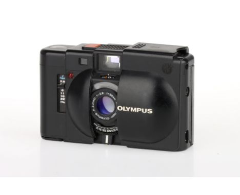 An Olympus XA 35mm Rangefinder Camera, black, body G, heavy wear, rangefinder patch present but dim, shutter working, optics 