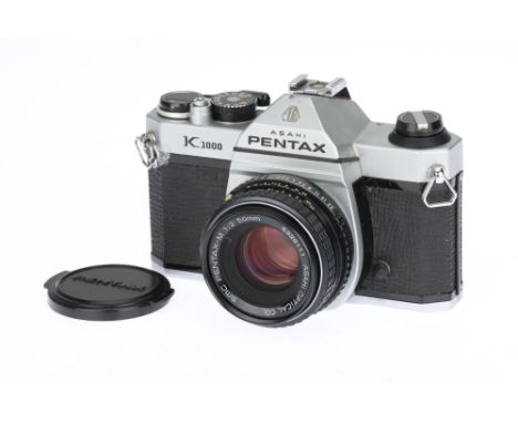 An Asahi Pentax K1000 35mm SLR Camera chrome, made in Japan, serial no.6395737, with a SMC Pentax-M f/2 50mm lens, shutter wo