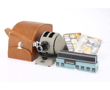 A Minox 3001 Slide Projector, together with its maker's carry case, together with two boxes of unused Minox slide mounts &amp