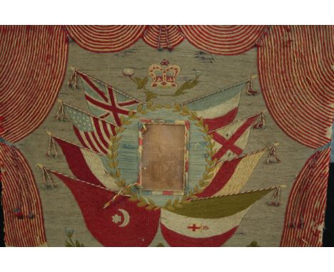 Patriotic embroidery with a military portrait at the centre. The artwork is nicely faded but much of the photograph is lost. 