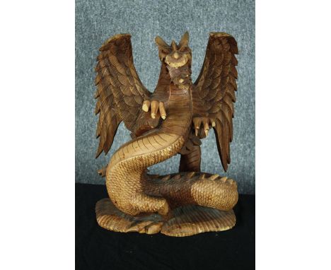 A carved Chinese dragon. Highly detailed with intricate scales and fangs. Twentieth century. H.44cm. 