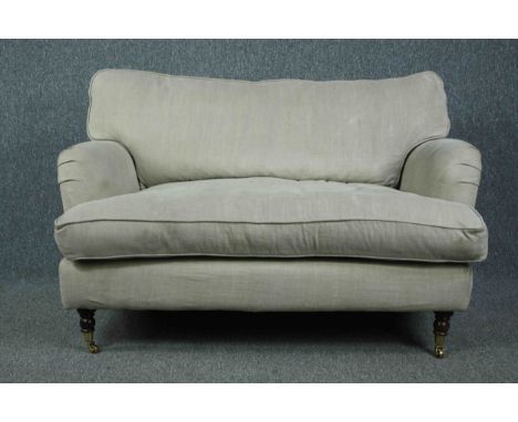 Sofa, contemporary in the Howard style on turned supports with brass cup casters. H.82 W.128 D.90cm. 