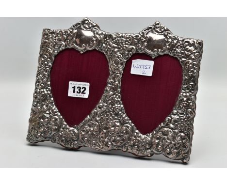 A MODERN SILVER PHOTO FRAME, of a rectangular form, embossed floral and scroll design featuring two heart shape apertures wit