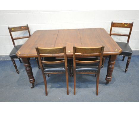AN EDWARDIAN WALNUT WIND OUT DINING TABLE, with canted corners, one additional leaf, with turned legs on ceramic casters, ope