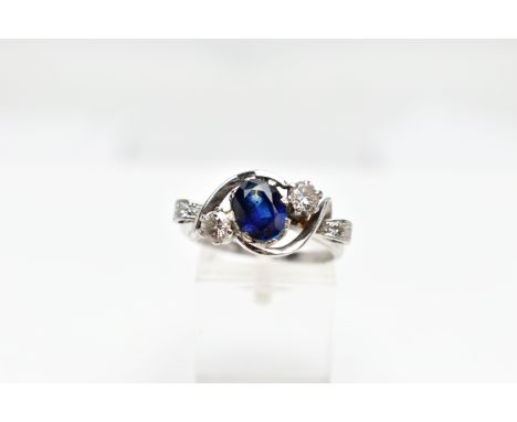 AN 18CT WHITE GOLD SAPPHIRE AND DIAMOND DRESS RING, the oval shape sapphire measuring approximately 7.8 x 5.8 x 3.8mm, with b