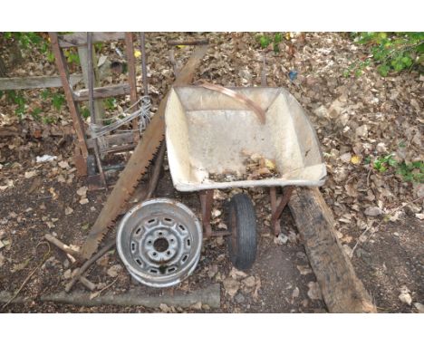 A SEVERLY WEATHERED VINTAGE WOODEN BEAM, a builders wheel barrow, two vintage sack trucks, a vintage cross cut saw and a car 