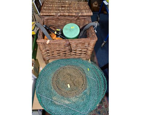 A WICKER FISHING BASKET, KEEP NETS AND REELS, comprising a vintage wicker fishing basket with carry strap, width 38cm x depth