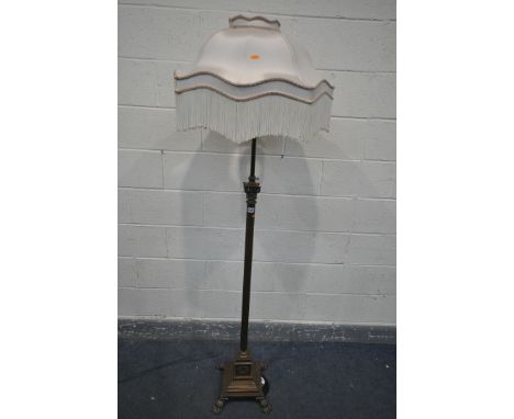 AN EARLY 20TH CENTURY FRENCH BRASS TELESCOPIC STANDARD LAMP, with Corinthian column, and a stepped base on claw feet, with fa