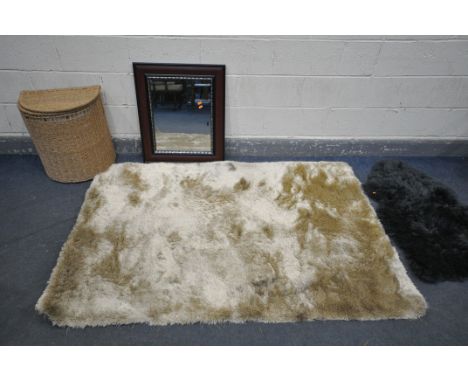 A WHISPER GOLDEN RUG, a small grey rug, a modern wall mirror, and a wicker linen basket (4)