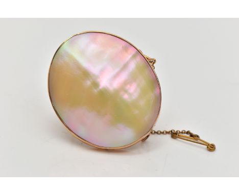 A MID 20TH CENTURY YELLOW METAL MOTHER OF PEARL BROOCH, the mother of pearl panel, within a rub over yellow metal surmount, s
