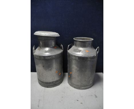 A PAIR OF VINTAGE NESTLE MILK CHURNS only one with lid