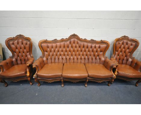 A LOUIS XV STYLE THREE PIECE LOUNGE SUITE, with tanned leather button back upholstery, comprising a three seater sofa, and tw