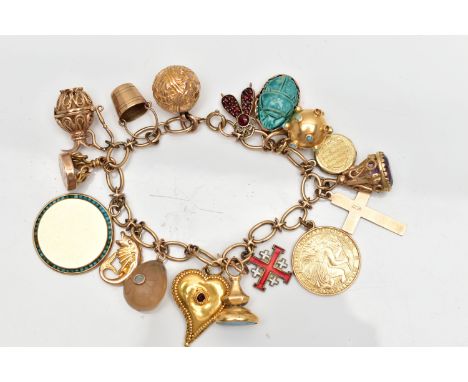 A 9CT GOLD CHARM BRACELET SUSPENDING SEVENTEEN CHARMS, the oval link chain with spring clasp, partial hallmarks for 9ct gold,