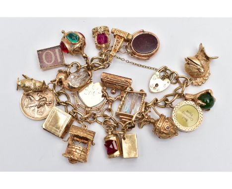 A 9CT YELLOW GOLD CHARM BRACELET, the curb link bracelet, suspending approximately twenty charms, to include an early 20th ce