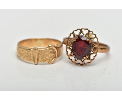 TWO YELLOW METAL RINGS, to include a buckle ring, stamped 9ct, together with a garnet single stone ring, stamped 9ct, approxi