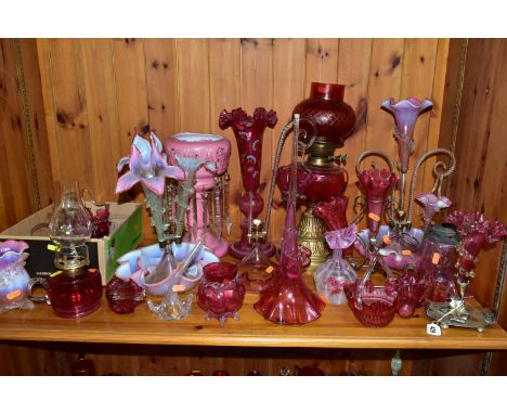 A COLLECTION OF CRANBERRY GLASS, PINK OPALESCENT AND OTHER GLASSWARES, to include an oil lamp with cranberry glass shade and 