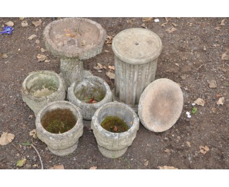 A SET OF FOUR COMPOSITE GARDEN PLANTERS 27cm in diameter and 24cm high ( some cracks), a tree trunk effect bird bath height 4