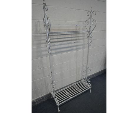 A WHITE PAINTED METAL CLOTHES RAIL, with one upper shelf, above a single rail, and a shoe shelf, width 94cm x depth 43cm x he