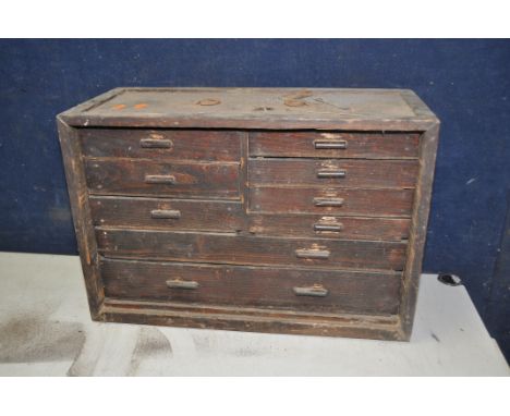 A VINTAGE ENGINEERS TOOLCHEST, wooden toolchest comprising nine draws of different sizes, to include tap and die sets, drill 