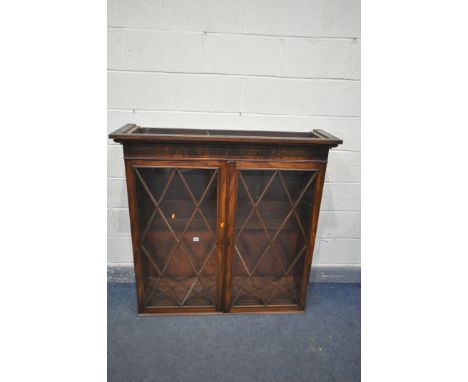 A GEORGIAN MAHOGANY SECRETAIRE BOOKCASE, the top with double astragal glazed doors, enclosing three shelves, over a base with