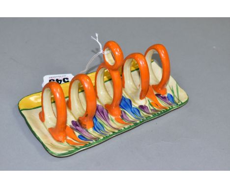 A CLARICE CLIFF CROCUS PATTERN TOAST RACK, painted with purple, blue and orange crocuses, a green and yellow band, and five o