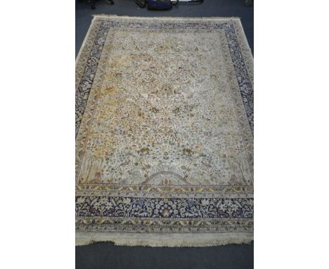 A 20TH CENTURY WOOLLEN TREE OF LIFE CARPET, with birds, flowers, leaves, animals, within a cream field, and a blue multi stra