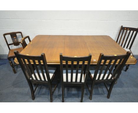 A 20TH CENTURY OAK EXTENDING DINING TABLE, with canted corners, one additional leaf on cylindrical and carved legs, and ceram