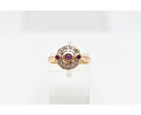 A 14CT GOLD RUBY AND DIAMOND RING, designed with a central circular cut ruby collet set, flanked with two other circular cut 