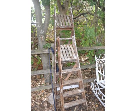 TWO VINTAGE WOODEN STEP LADDERS the tallest being 197cm high