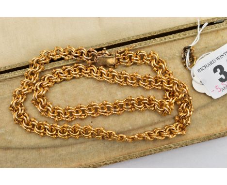 A YELLOW METAL FANCY LINK CHAIN, intertwined multi-link hollow chain, fitted with an integrated box clasp and additional figu