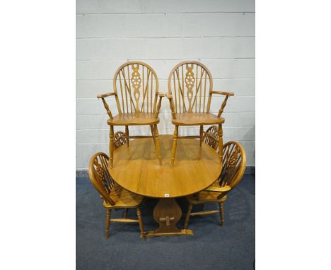 A LIGHT OAK CIRCULAR DROP LEAF DINING TABLE, diameter 120cm, closed width 49cm x height 74cm, along with a set of six wheel b