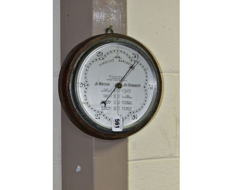 A WILSON FORECAST WALL BAROMETER on a circular oak mount, diameter 25cm, registration number 710284 (the chrome frame is slig