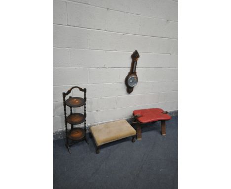 A 20TH CENTURY HARDWOOD CAMEL STOOL, a mahogany aneroid barometer, a folding oak cake stand and a long footstool (condition:-