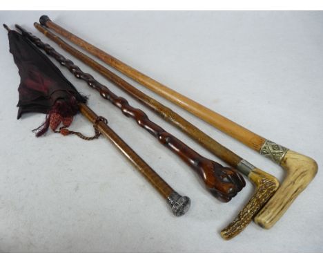 SILVER MOUNTED PARASOL, a 19th century clasped hand walking stick and two antler handled sticks