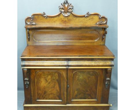 VICTORIAN MAHOGANY CHIFFONIER - the shelf back with applied carvings over a two drawer, two door base section on a plinth bas