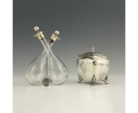 An Edwardian silver tea caddy, of bombe form, atop four paw feet, the hinged cover with flame finial, William Hutton &amp; So