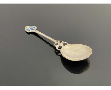 A George V Arts and Crafts silver spoon, perhaps referred to as an ice-cream or fruit spoon, the top decorated with blue enam