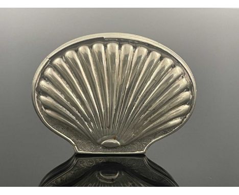 An early eighteenth-century silver snuff box, of shaved oval form, the hinged cover embossed to resemble a scallop shell, eng