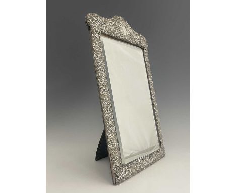 V A Victorian silver mounted dressing mirror, of shaped rectangular form, with embossed silver mount decorated with scrolls, 