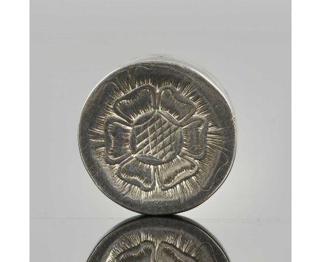 A late seventeenth century silver patch box, of circular form, the detachable cover decorated with a Tudor rose, both top and