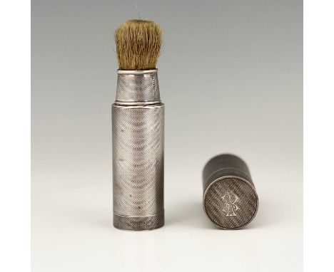 A set of two George V silver gentleman's travelling toilet accoutrements, to include a shaving brush and a similar canister, 
