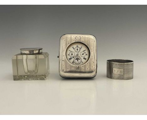 A George V silver-mounted pocket watch stand, of cushioned rectangular form, the silver decorated with vertical bands of engi