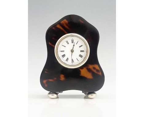 V A George V silver-mounted tortoiseshell carriage clock or boudoir timepiece, of shaped escutcheon form, atop four bun feet,