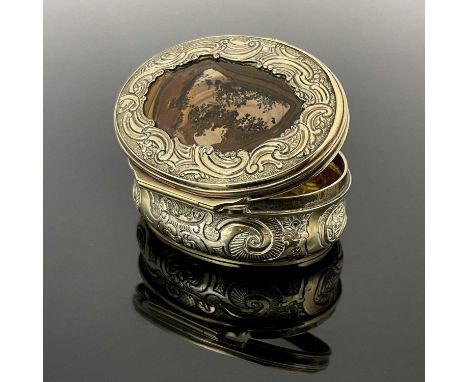 A George IV silver gilt snuff box, of oval form, in the Rococo style, the cover inset with banded moss agate panel, the body 