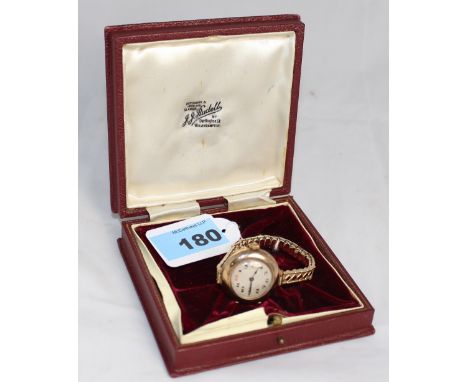 		A Rolex lady's wristwatch, 9ct Dennison case and plated expanding bracelet. C.R. Runs, case and dial good