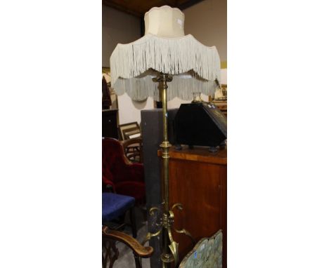 		A fine Edwardian brass telescopic oil lamp standard with wrought scrollwork support. Converted to electric light