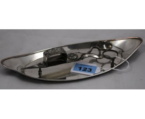 		A plated candle snuffer with a Georgian associated boat shaped tray marked Holy, D Wilkinson & Co 1784