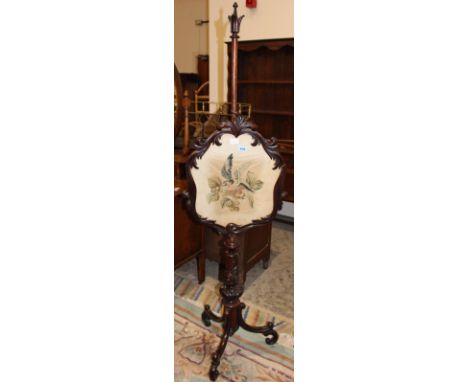 		A Victorian rosewood pole screen, the screen with foliate carved frame and embroidered panel depicting a bird raised on a l