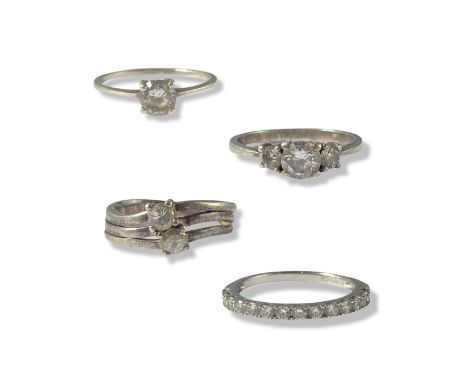 Collection of four silver and CZ rings all of different designs weighing 7.62 grams collectivleySilver and single CZ ring - w