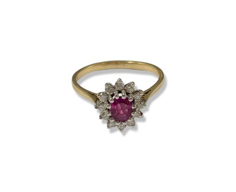 14ct Yellow gold Ruby and Diamond cluster ring featuring an oval ruby stone weighing approximately 0.40cts surrounded by 12 r